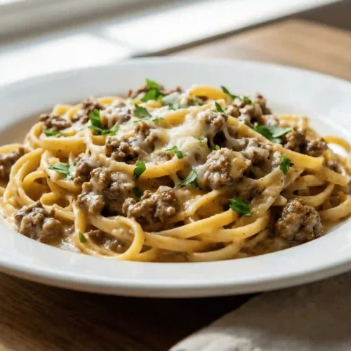 one-pot creamy beef and garlic butter pasta cooking in a skillet