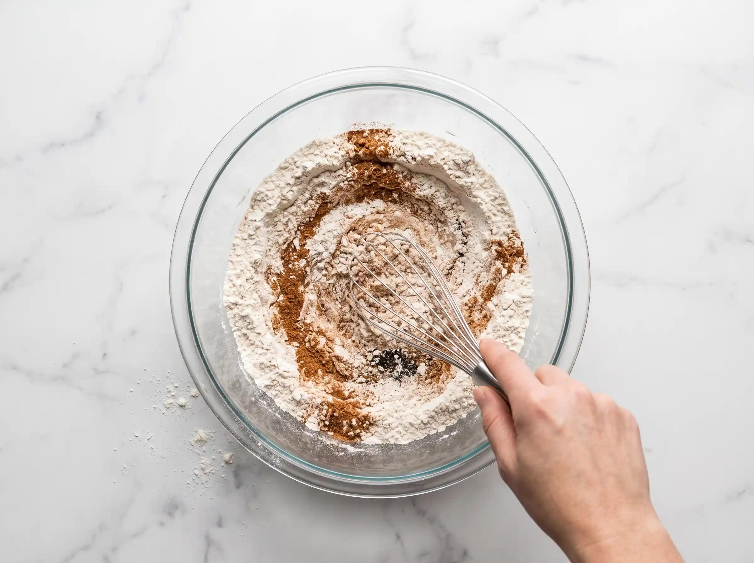 Mixing pumpkin puree, eggs, and oil in a separate bowl for the wet ingredients of the pumpkin cream cheese muffins.